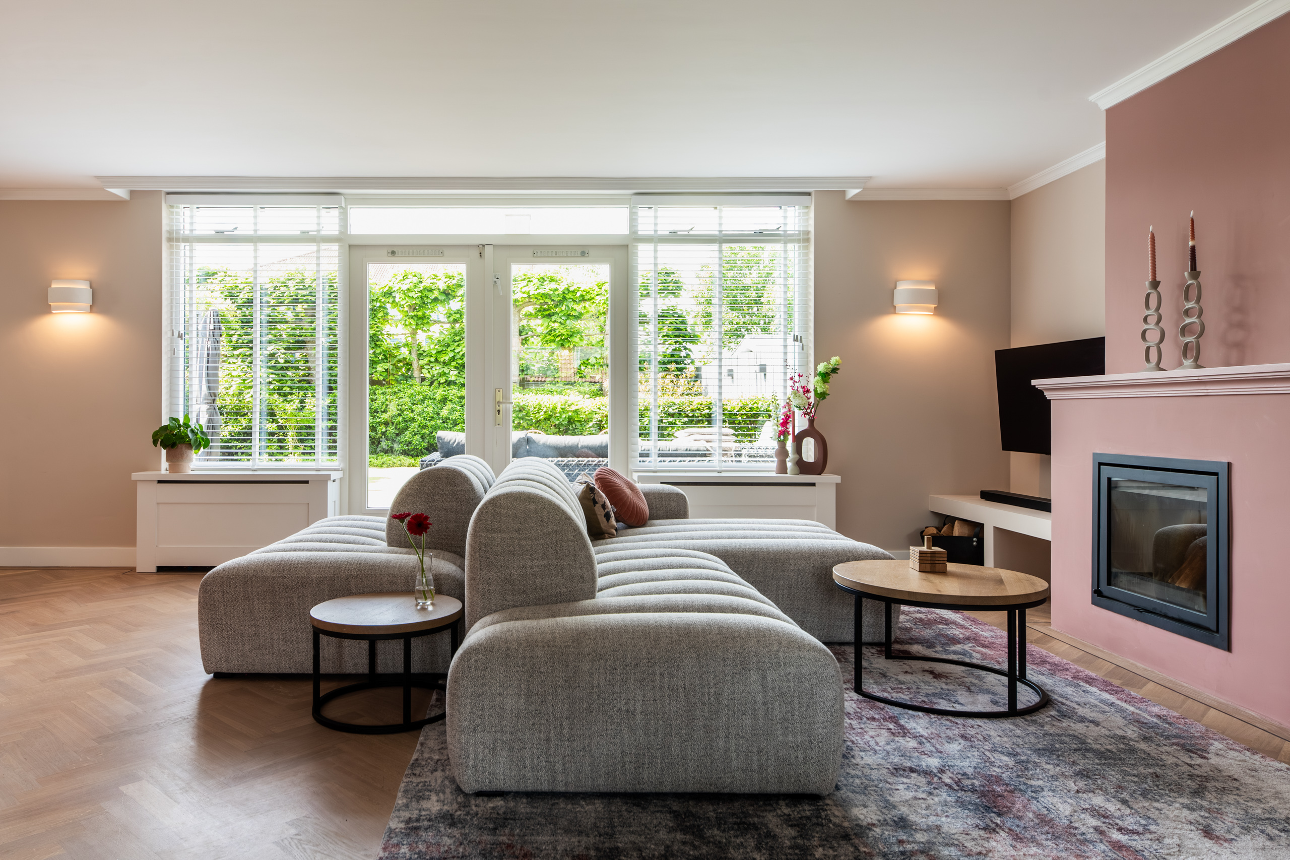 Interieurontwerp woning Bennebroek: woonkamer met terra-roze schouw en modulaire bank, restyling door Authentic Interiors