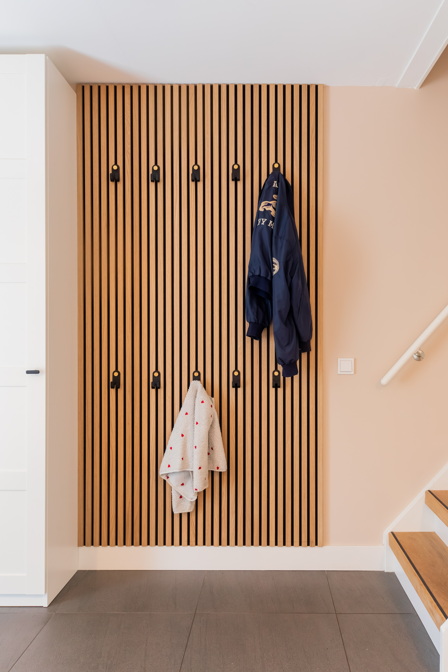 Eiken lattenwand met kapstok in de hal, interieurontwerp woning Bennebroek door Authentic Interiors